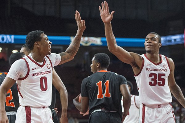 Desi Sills (0) and Reggie Chaney of Arkansas high five after a play in the first half vs Tusculum Friday, Oct. 26, 2018, during an exhibition game in Bud Walton Arena in Fayetteville.