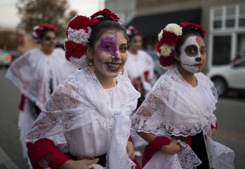 NWA Democrat-Gazette/CHARLIE KAIJO The smiling, often playful "sugar skull" makeup and colorful costumes of Dia de los Muertos are iconic traditions of the holiday, celebrating the memory of love ones who have passed as well as the cycle of life and death.