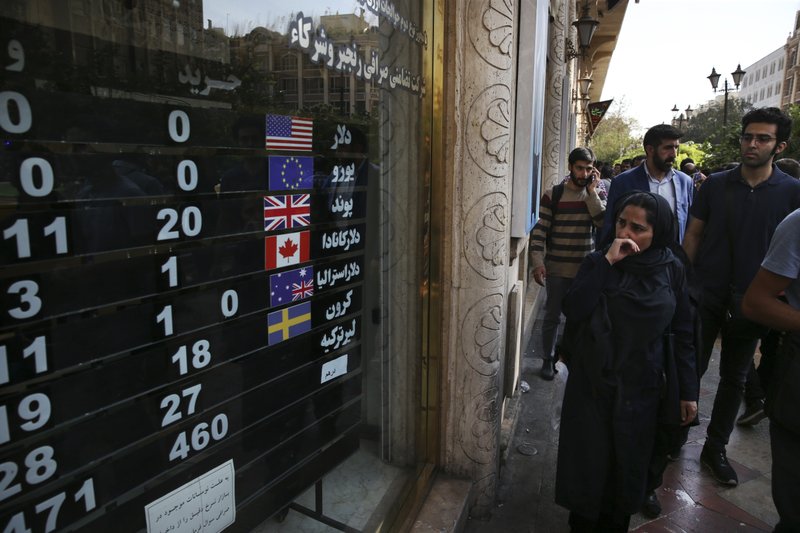 In this Oct. 2, 2018, file photo, an exchange shop in downtown Tehran, Iran displays rates for various currencies. (AP Photo/Vahid Salemi, File)