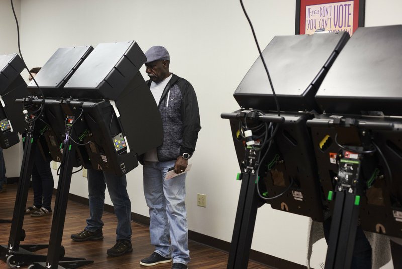 NWA Democrat-Gazette/CHARLIE KAIJO Curtis Foote of Bella Vista votes, Friday, October 26, 2018 at the Benton County Administration office in Bentonville. 

Voting hit record numbers in both counties Benton and Washington counties.