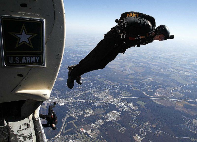 Sgt. Jason Bauder with the Army Golden Knights Parachute Team exits the airplane at 13,000 feet to begin the team’s performance Saturday during the Thunder Over the Rock airshow at Little Rock Air Force Base in Jacksonville. For more photos, see www.arkansasonline.com/galleries,