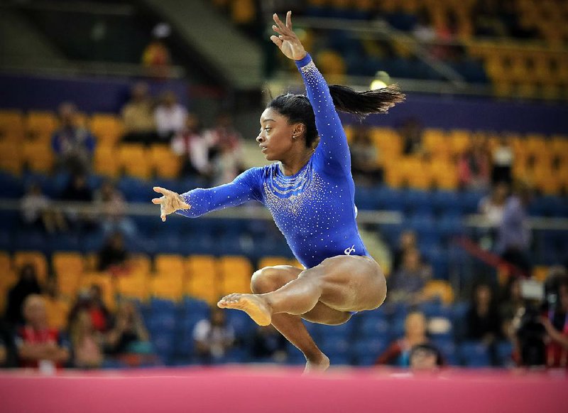 Simone Biles of the United States posted the top all-around score of 60.965 at the Gymnastics World Championships in Doha, Qatar, one day after going to the emergency room with a kidney stone. 