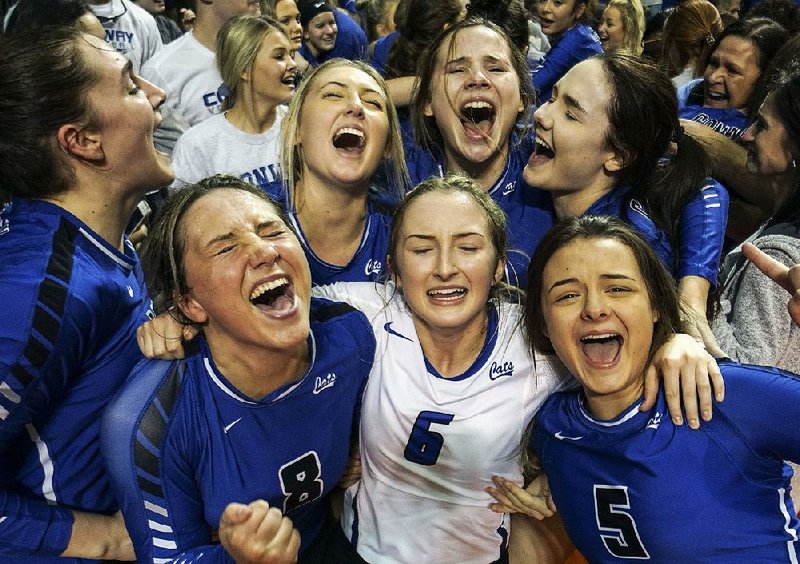 Members of the Conway volleyball team celebrate after defeating Fort Smith Southside 25-13, 24-26, 25-15, 25-22 for the Class 6A state championship Saturday at Bank OZK Arena in Hot Springs. It was the first title in 20 years for the Lady Wampus Cats. For more photos, go to www.arkansasonline.com/galleries. 