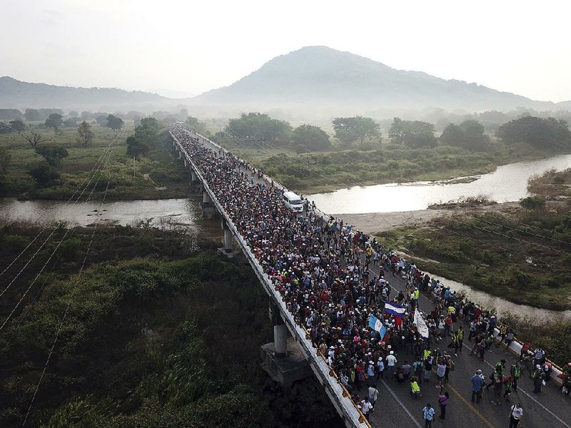 Members of a migrant caravan cross a bridge Saturday between the Mexican states of Chiapas and Oaxaca. 