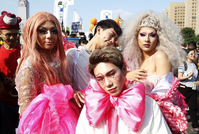 Costumed participants pose Saturday during the gay-pride parade in Taipei, Taiwan. 