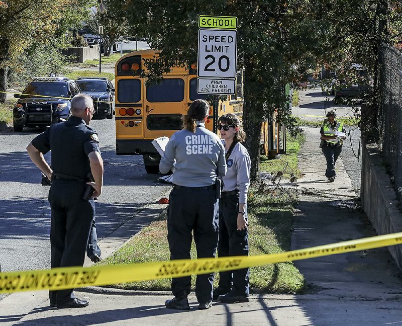 Little Rock police and crime scene technicians at the scene of a bus accident on the 9000 block of Towne Oaks Drive in Little Rock Monday afternoon. According to police, a Pulaski County Special School District driver was killed after he was struck by his own bus.