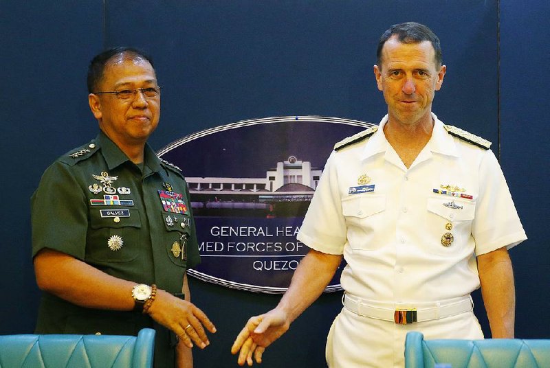 Adm. John Richardson (right), chief of Naval Operations of the U.S. Navy, and Philippine Armed Forces Chief Gen. Carlito Galvez Jr. arrive for a news conference Monday in Manila, Philippines.