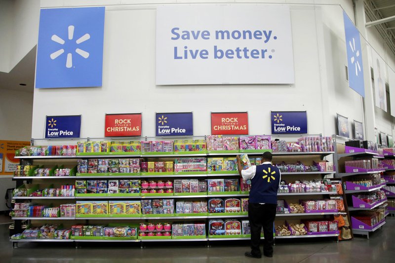 In this Nov. 9, 2017, file photo, Walmart employee Kenneth White scans items while conducting an exercise during a Walmart Academy class session at the store in North Bergen, N.J. (AP Photo/Julio Cortez, File)