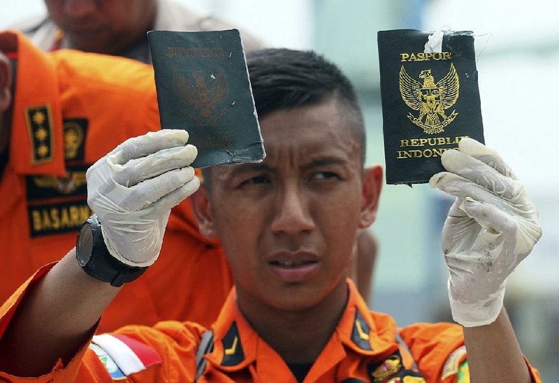 An Indonesian responder Tuesday displays passports recovered from the area where Lion Air Flight 610 crashed into the Java Sea early Monday with 189 people on board. A top military official said the possible location of the wreckage has been identified and a team was being sent to the site as investigators continue to look for the cause of the crash. 