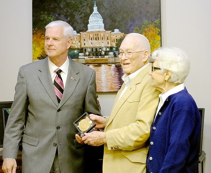 Lynn Atkins/The Weekly Vista Congressman Steve Womack poses with Pat Patterson and his wife Jan after presenting the Congressional Gold Medal to the World War II veteran. Patterson served with the Office of Strategic Services, a forerunner of the CIA.
