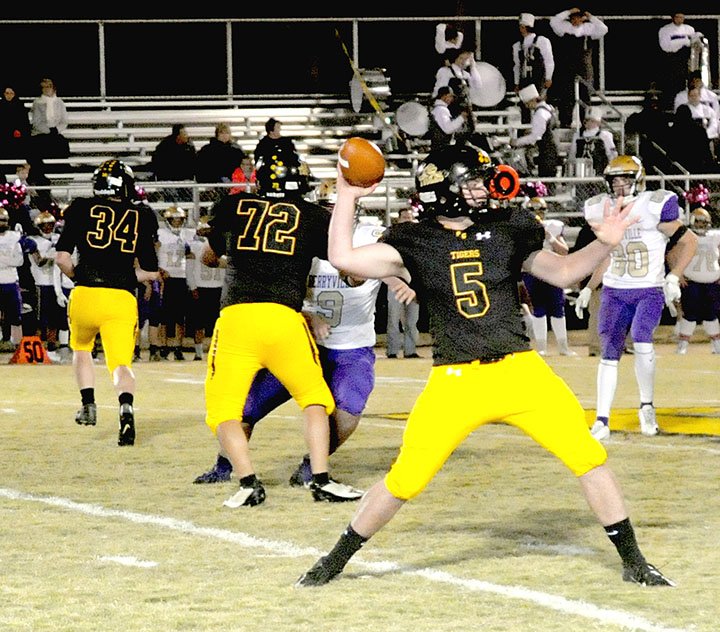 MARK HUMPHREY ENTERPRISE-LEADER Prairie Grove senior quarterback Ethan Guenther drops back to pass. Guenther put the finishing touches on a hard-fought, 22-7, win by the Tigers with a quarterback sneak for a 1-yard touchdown in the fourth quarter.