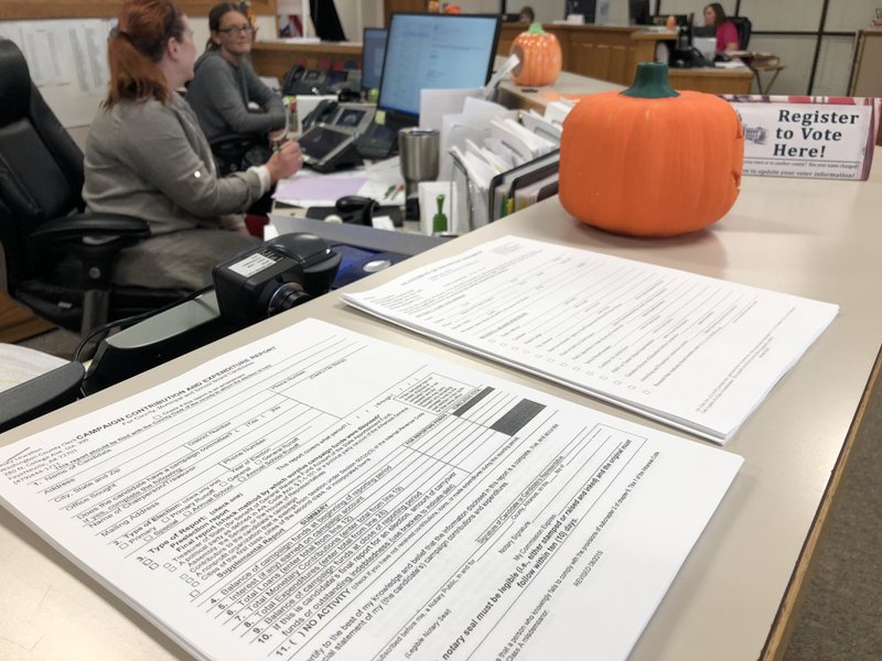 NWA Democrat-Gazette/STACY RYBURN A stack of pre-election and statement of financial interests forms sit at the front desk of the Washington County Clerk's Office on Tuesday in Fayetteville.
