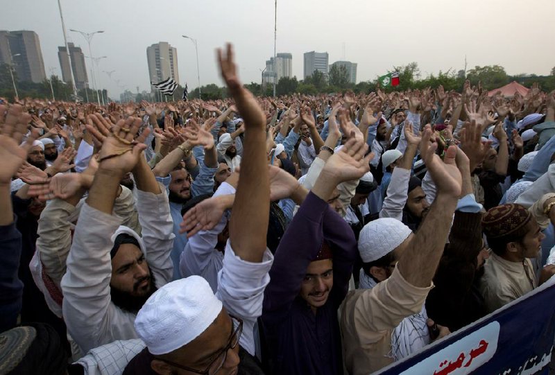 Pakistani religious students and other protesters raise their hands Wednesday in condemnation of the country’s Supreme Court landmark ruling acquitting Asia Bibi, a Roman Catholic mother of five who was sentenced to death for blasphemy in 2010.