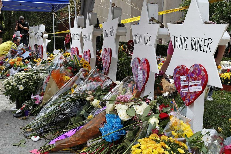 Flowers surround Stars of David on Wednesday outside the Tree of Life synagogue in Pittsburgh as part of a makeshift memorial for the 11 people killed Saturday. 