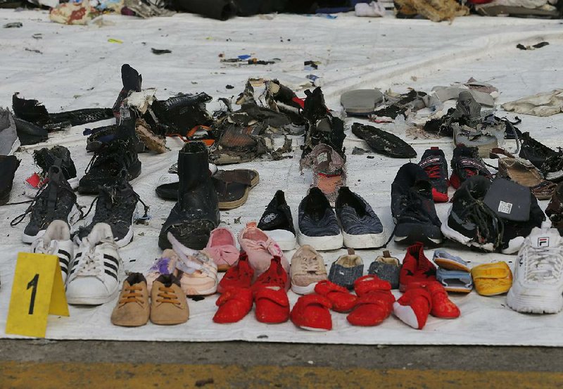 Shoes and other personal belongings pulled from the water where a Lion Air jet is believed to have crashed are displayed Wednesday for people to identify at the Port of Tanjung Priok in Jakarta, Indonesia. 