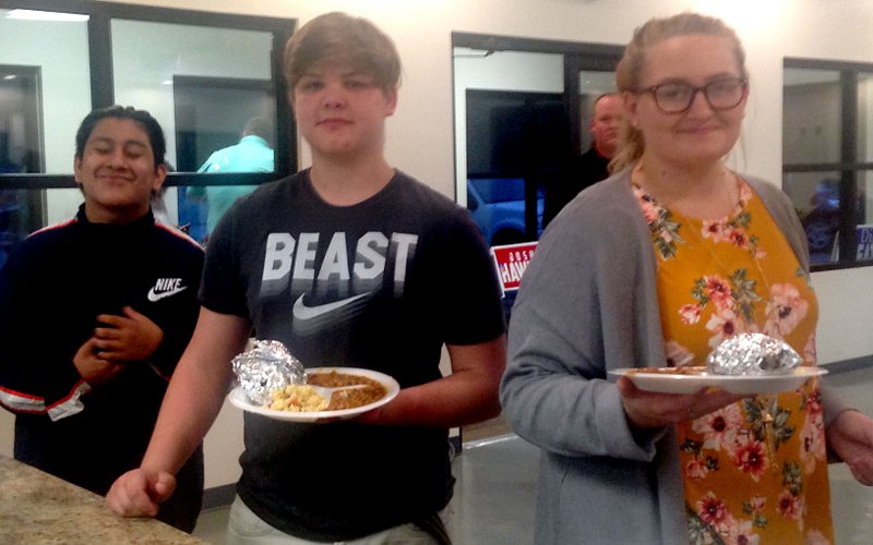 Sally Carroll/McDonald County Press Advocates for Better Choices participants Victor Morales, Robert Newkirk and Lena Kirch pose while serving Republican Club members some dinner at a meeting on Oct. 25. Students with the ABC program helped cook and serve dinner.
