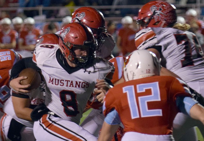 RICK PECK/SPECIAL TO MCDONALD COUNTY PRESS McDonald County running back Oakley Roessler (8) runs for some of his 106 yards before Webb City's Kade Hicks (12) makes a stop during the Cardinals 55-13 win on Oct. 26 at Webb City High School.