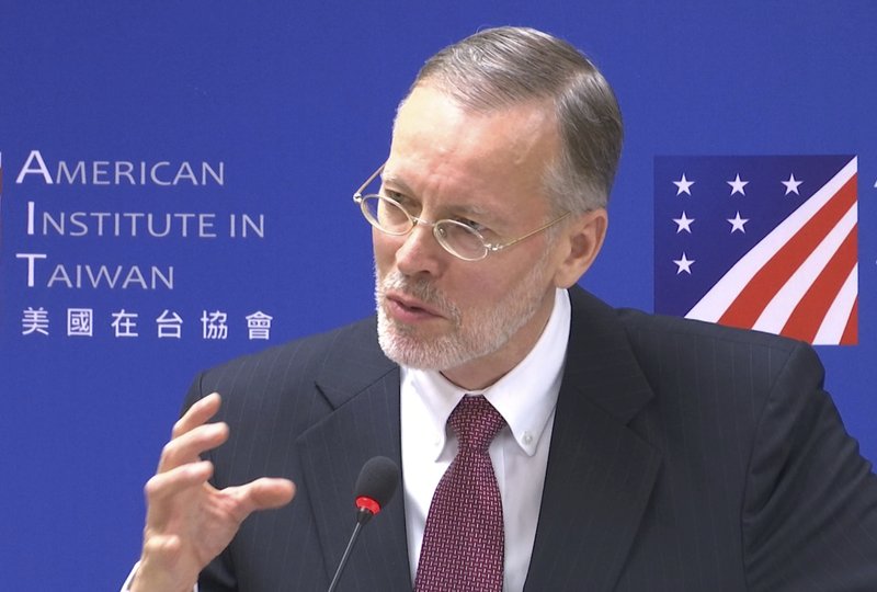 In this image made from video, American Institute in Taiwan director Brent Christensen gestures while speaking during a press conference in Taipei, Taiwan, Wednesday, Oct. 31, 2018. Washington's de facto ambassador to Taiwan reassured the self-governing island of American security backing against threats from China. (AP Photo)