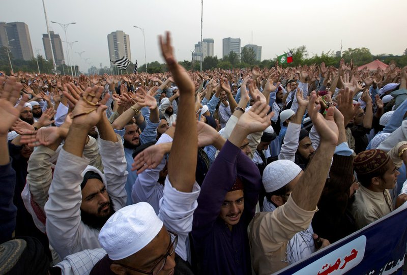 Pakistan religious students and other protesters raise their hands to condemn Supreme Court's decision in favor of a Christian woman Asia Bibi, in Islamabad, Pakistan, Wednesday, Oct. 31, 2018. Pakistan's top court on Wednesday acquitted Bibi who was sentenced to death under the country's controversial blasphemy law, a landmark ruling that sparked protests by hard-line Islamists and raised fears of violence. (AP Photo/B.K. Bangash)