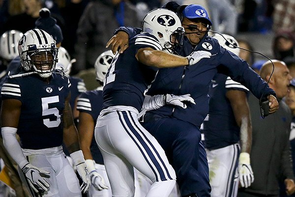 BYU coach Kalani Sitake celebrates with defensive back Austin Lee (11) after Lee intercepted a Hawaii pass during an NCAA college football game Saturday, Oct. 13, in Provo, Utah. (Isaac Hale/Daily Herald via AP)

