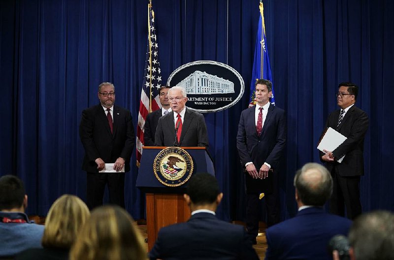 “It is time for China to join the community of lawful nations,” U.S. Attorney General Jeff Sessions (at lectern) said during a news conference Thursday in Washington. 
