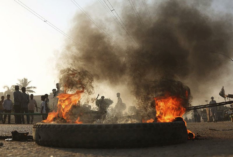 Protesters block a road and burn tires Thursday in Karachi, Pakistan, to protest the acquittal of a Christian woman who had been sentenced to death for blasphemy. 