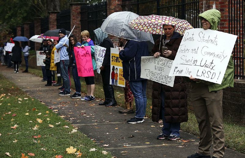 Teachers and people who support them protest Thursday in front of the Governor’s Mansion in Little Rock. The state-run Little Rock School District and the Little Rock Education Association employees’ union are in talks over a new contract. 