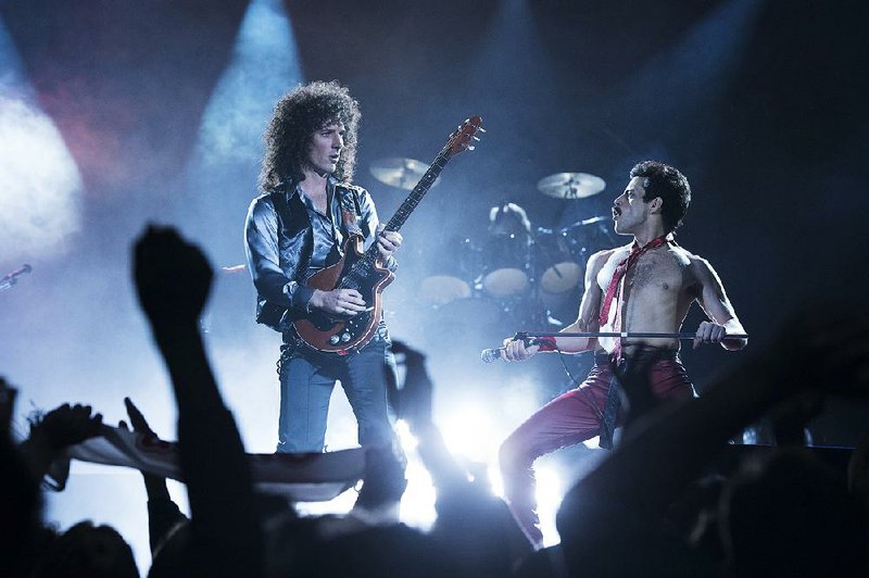 Queen guitarist Brian May (Gwilym Lee) and frontman Freddie Mercury (Rami Malek) rock on in Bohemian Rhapsody, a curious blend of bio-pic and Behind the Music-style docu-drama that is credited to (but maybe not really the complete fault of) Bryan Singer.
