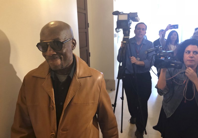  In this Oct. 10, 2018 file photo, plaintiff DeWayne Johnson, a school groundskeeper who says Roundup weed-killer caused his cancer, leaves a courtroom in San Francisco. A Northern California groundskeeper says he will accept a judge's reduced verdict of $78 million against Monsanto after a jury found the company's weed killer caused his cancer. DeWayne Johnson's attorney informed the San Francisco Superior Court on Wednesday, Oct. 31, 2018. (AP Photo/Paul Elias, File)