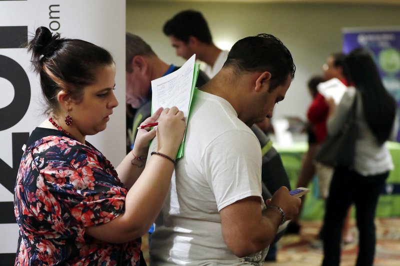 Loredana Gonzalez, of Doral, Fla., fills out a job application at a JobNewsUSA job fair in Miami Lakes, Fla., in this Jan. 30 file photo.