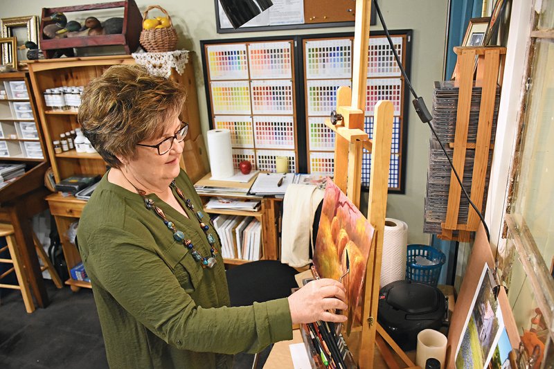 Evening Shade artist Eva Haley puts the finishing touches on one of her paintings using a palette knife. Haley received the $600 First Community Bank Purchase Award in the recent Plein on Main art contest sponsored 
Sept. 29 and 30 by Gallery 246.