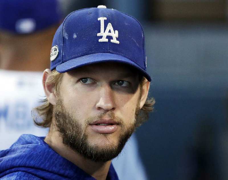 In this Oct. 16, 2018 file photo, Los Angeles Dodgers pitcher Clayton Kershaw watches before Game 4 of the National League Championship Series baseball game against the Milwaukee Brewers in Los Angeles. 