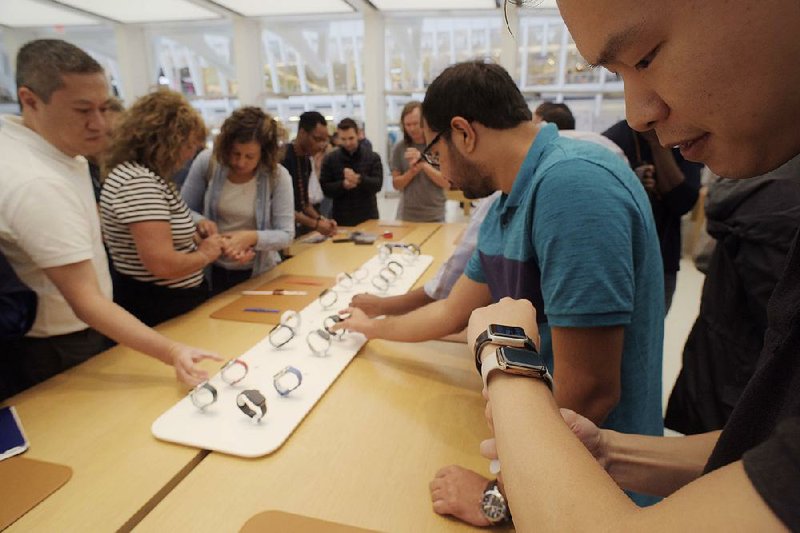 Customers check out Apple watches, including the new Series 4, in September at an Apple store in New York. Apple shares plummeted Friday after a disappointing earnings report. 