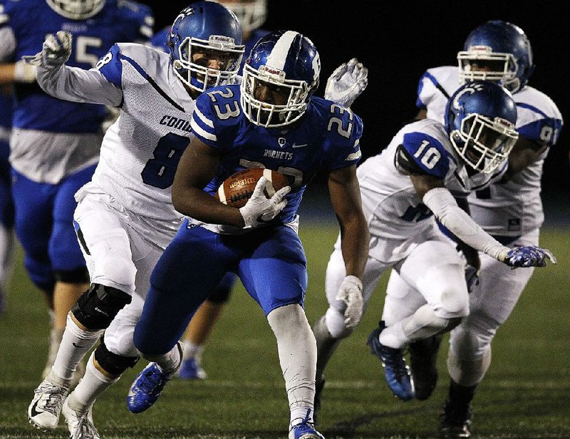 Bryant running back Latavion Scott (23) shakes off Conway defensive back Jason Cruz (8) during  the third quarter of Bryant’s 40-10 victory Friday at Bryant.