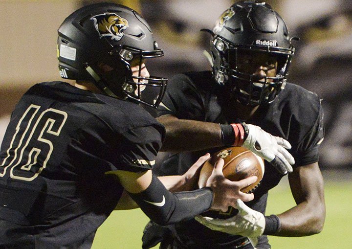 Bentonville High School quarterback Easton Hughes (16) passes the ball to Bentonville High School Preston Crawford (1) during a football game, Friday, November 2, 2018 at Bentonville High School in Bentonville.