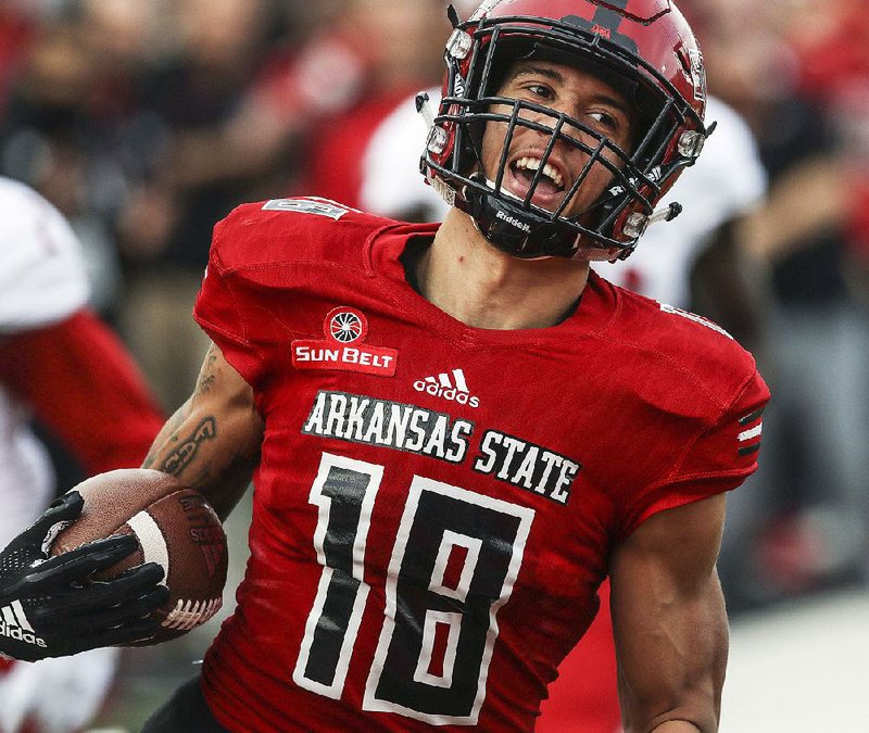 Arkansas State wide receiver Justin McInnis scores on a 78-yard reception during the Red Wolves’ victory over South Alabama on Saturday at Centennial Bank Stadium in Jonesboro. See more photos at arkansasonline.com/galleries.