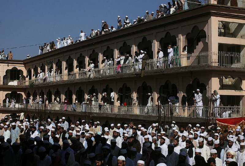 Mourners gather Saturday at an Islamic seminary to bid farewell to Pakistani cleric Maulana Sami ul-Haq in Akora Khattak, northwest of Islamabad.