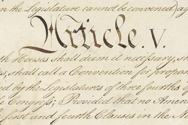 This photo made available by the U.S. National Archives shows a portion of the United States Constitution with the title of Article V. For the past two centuries, constitutional amendments have originated in Congress, where they need the support of two-thirds of both houses, and then the approval of at least three-quarters of the states. But under a never-used second prong of Article V, amendments can originate in the states. (National Archives via AP)