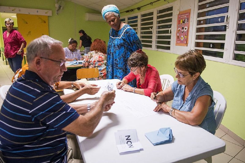 Polling station officials count the votes as part of the independence referendum in Noumea, New Caledonia’s capital, on Sunday. 