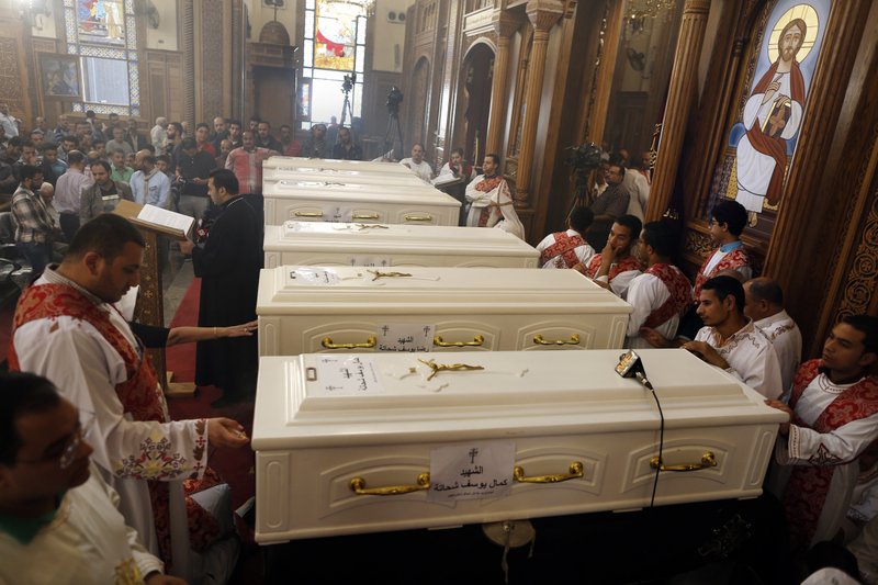 FILE - In this Nov. 3, 2018 file photo, coffins of slain Coptic Christians lie in the Church of Great Martyr Prince Tadros, during their funeral service in Minya, Egypt. Egypt says security forces have killed 19 militants in a shootout, including the gunmen suspected of killing seven Christians in an attack on pilgrims traveling to a remote monastery on Saturday. The Interior Ministry said Sunday the militants were tracked to a desert hideout west of the central Minya province, where Friday's attack took place. (AP Photo/Amr Nabil, File)