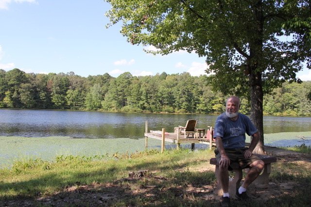 Mike Oglesby, 73, sits on the edge of his property in Lake Sandy Acres in southern Saline County.