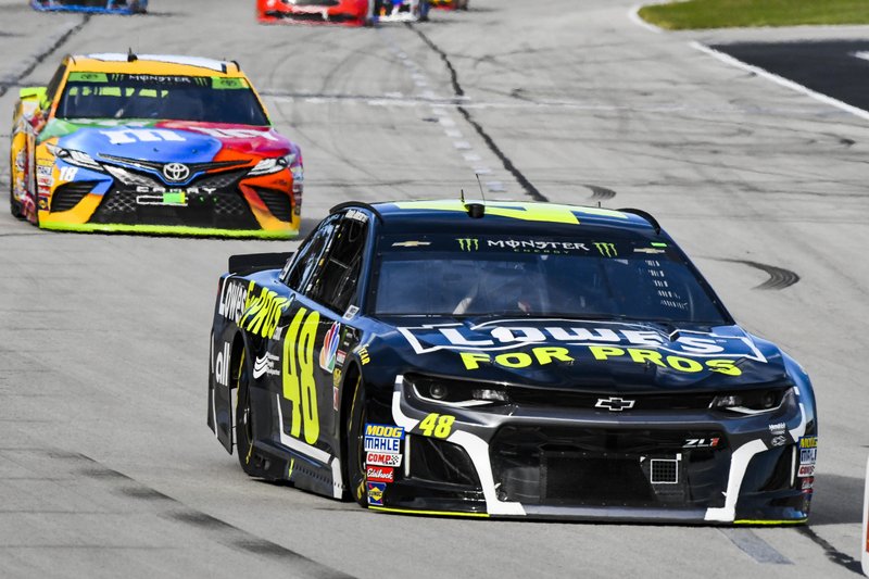 Jimmie Johnson (48) leads Kyle Busch (18) into Turn 1 during a NASCAR Cup auto race at Texas Motor Speedway, Sunday, Nov. 4, 2018, in Fort Worth, Texas. (AP Photo/Larry Papke)