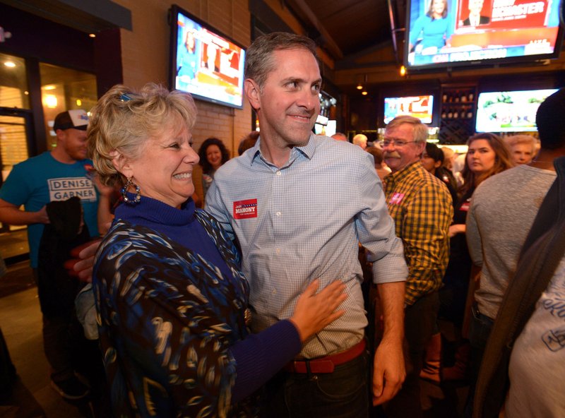 Denise Garner, Democratic candidate for State House District 84, gets a hug Tuesday, Nov. 6, 2018, from Greg Leding, Democratic candidate for State Senate District 4, as she enters the room during a watch party for the Washington County Democratic Party of Arkansas at Farrell's Lounge in Fayetteville.