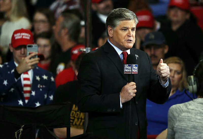 Television personality Sean Hannity does his show from the floor of a campaign rally Monday, Nov. 5, 2018, in Cape Girardeau, Mo. (AP Photo/Jeff Roberson)
