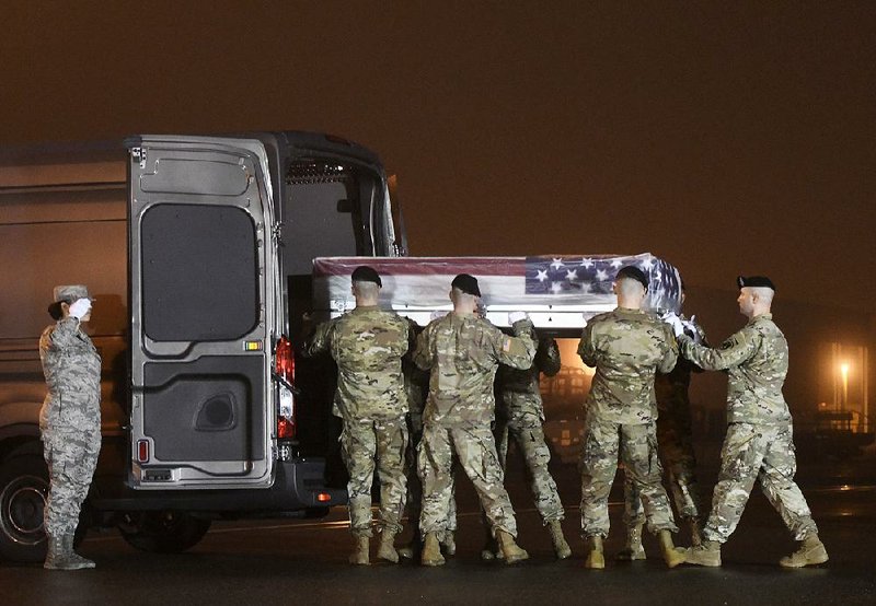 An Army team loads the remains of Maj. Brent Taylor into a vehicle Tuesday at Dover Air Force Base in Delaware.