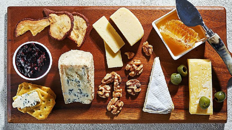 On this board, clockwise from top left: dried pears, havarti, honey with honeycomb, English cheddar, olives, Camembert, walnuts, Castello Creamy Blue, crackers and currant jam. Stacy Zarin Goldberg for The Washington Post.