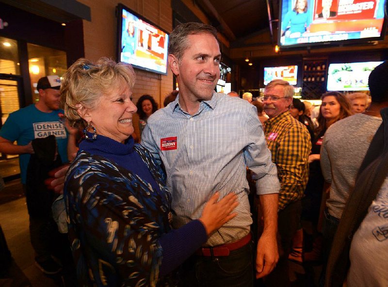 Denise Garner, the winner of the House District 84 race, gets a hug Tuesday from Greg Leding, who was elected to the state Senate’s District 4 seat, during a watch party at Farrell’s Lounge in Fayetteville. Garner defeated incumbent Republican Rep. Charlie Collins.