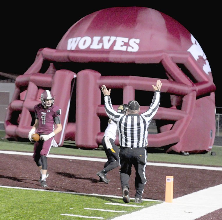 MARK HUMPHREY ENTERPRISE-LEADER Lincoln senior wide receiver Sterling Morphis fought off an attempted tackle by a Prairie Grove Tiger latching onto his hand as he crossed the goal line with a 27-yard touchdown reception in the second quarter Friday. Morphis caught 7 passes for 172 yards as the Wolves knocked off Prairie Grove, 59-48, to earn the third playoff seed from the 4A-1 Conference. Lincoln finished the regular season 8-2 overall and 5-2 in conference.