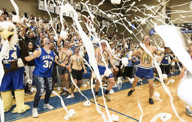 Photo courtesy of John Brown University John Brown students throw toilet paper after Luke Harper's 3-point shot 14 seconds into Saturday's season-opener against Ecclesia in the annual Toilet Paper Game at Bill George Arena.