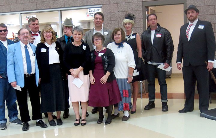 Westside Eagle Observer/SUSAN HOLLAND The 10 suspects in the "Who Dun It?" murder mystery game at the Gravette Public Library gala Saturday evening, Nov. 3, are joined by Will Trentham, master of ceremonies for the evening, and David Keck, who played the role of Detective Clarence O'Dell.